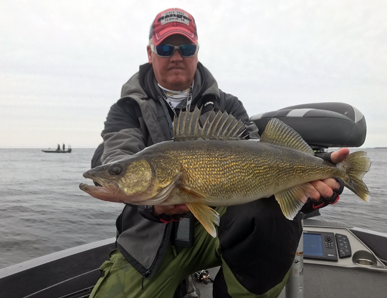 green bay fishing guide bret alexander holding small mouth bass with customer