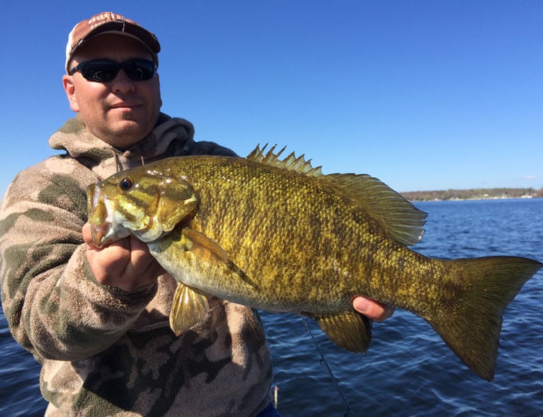 large smallmouth bass with guide